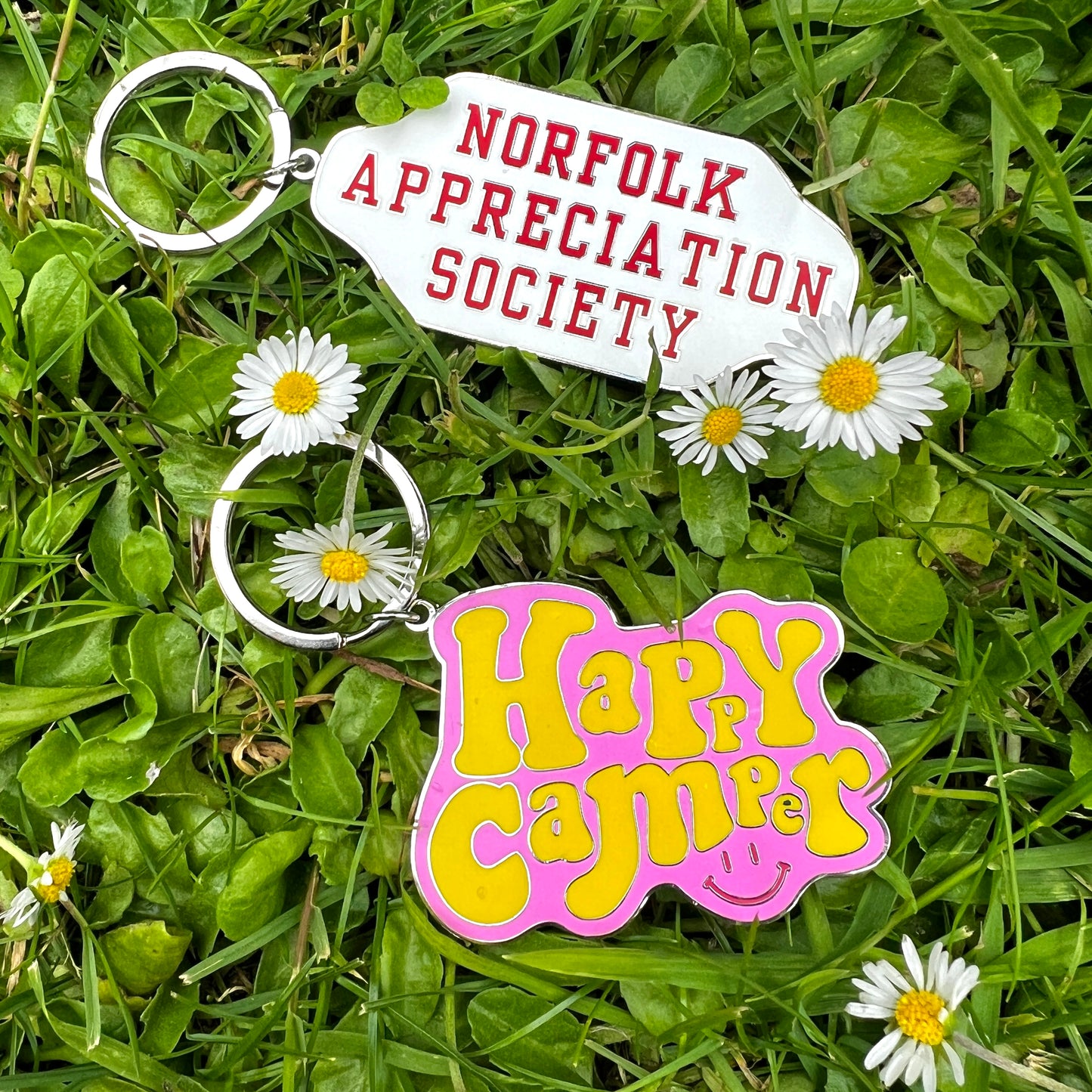 Norfolk appreciation and happy camper key rings on grass