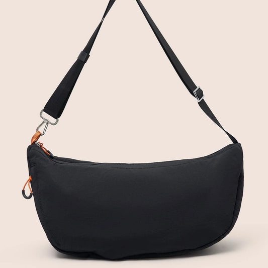 Gandys Black shoulder bag with a strap on a beige background