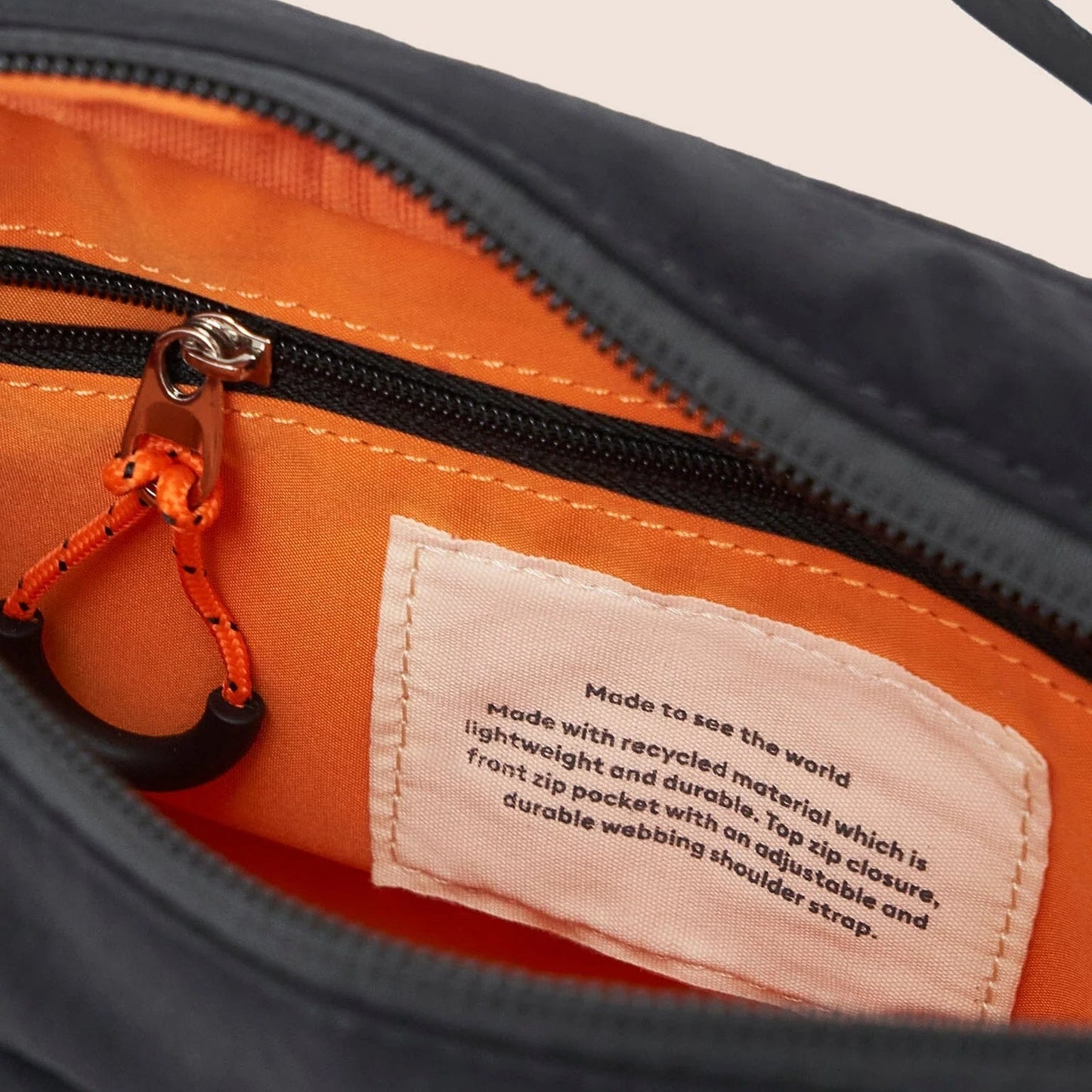 Close-up of a bag with a label on an orange and black background