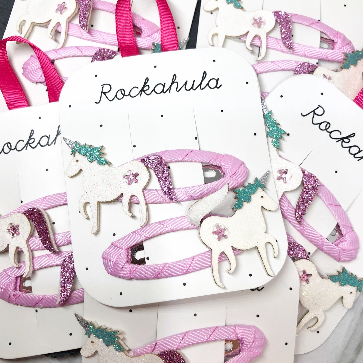 We believe in unicorns! And so can you, with these two glittery beauties, each one secured to a grosgrain ribbon wrapped clip. Rockahula children's hair clips - Glitter & Mud