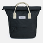 A black canvas tote bag with cream-colored webbed handles and a white brand label reading 'KIND BAG LONDON' on the front, set against a light gray background.
