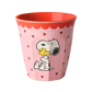 A pink melamine cup featuring a cartoon illustration of Snoopy hugging Woodstock, with small red hearts scattered around the cup and a red scalloped rim.
