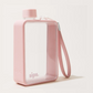 A pink rectangular travel tumbler with a clear front window, matching pink lid, and an attached pink wrist strap, photographed on a clean off-white background.