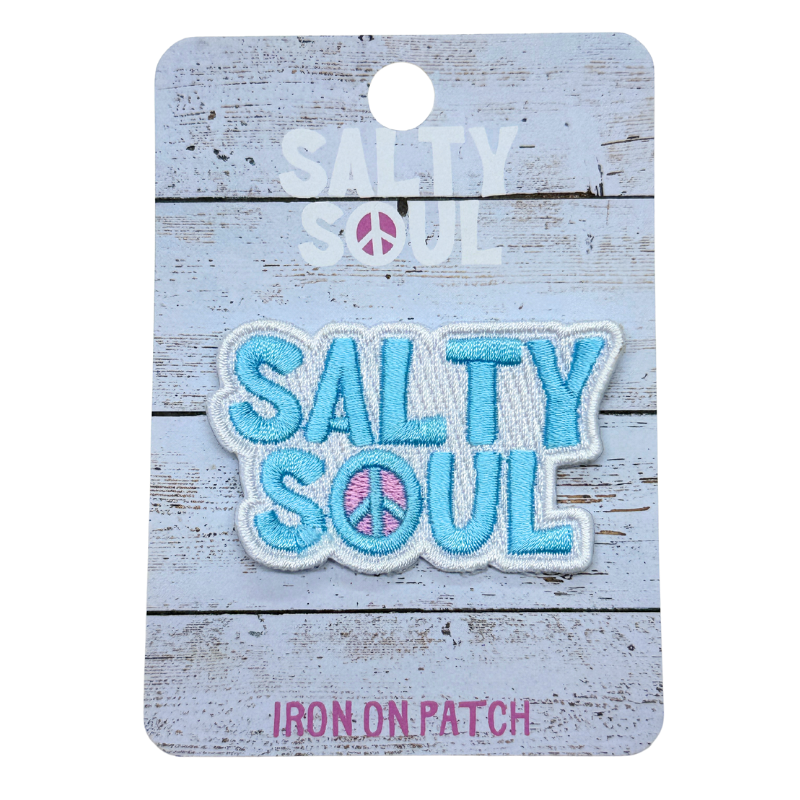 Embroidered blue and white 'Salty Soul' iron on patch with CND in the 'O' on a wooden textured card with salty soul branding.