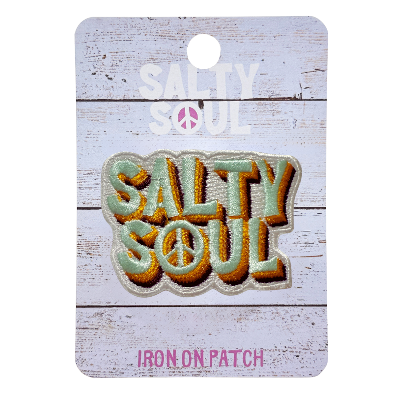 Embroidered 'Salty soul' retro style text iron on patch. on a wooden textured 'Salty soul' branded card