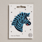 Embroidered iron on Blue Zebra head patch, on a white card with black stars and 'Petra Boase' Branding 
