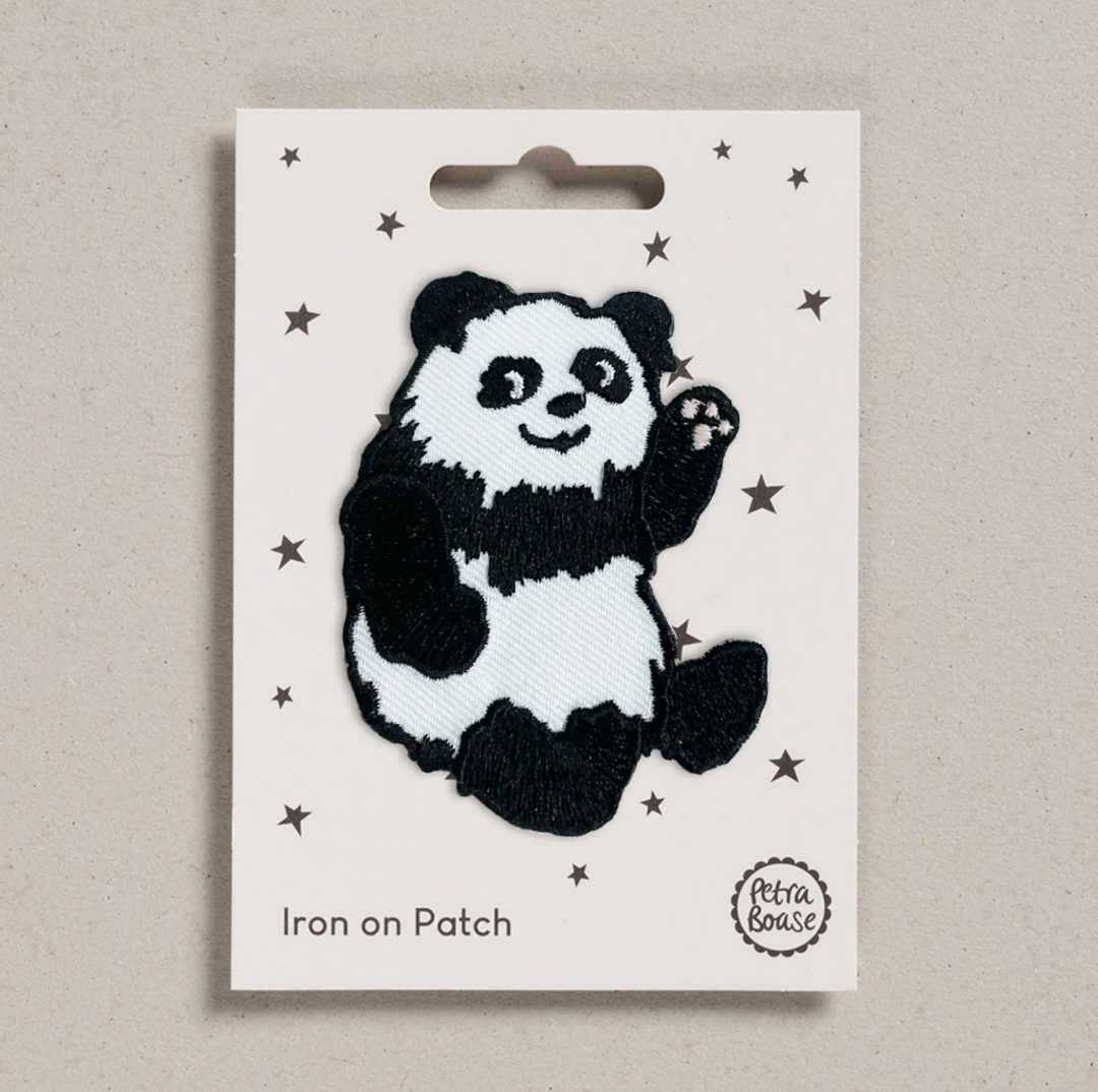 Embroidered iron on Panda patch, on a white card with black stars and 'Petra Boase' Branding 