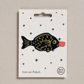 Embroidered iron on Soy sauce fish  patch, on a white card with black stars and 'Petra Boase' Branding 