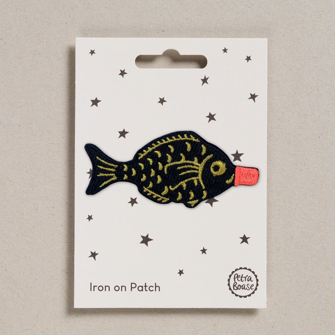 Embroidered iron on Soy sauce fish  patch, on a white card with black stars and 'Petra Boase' Branding 