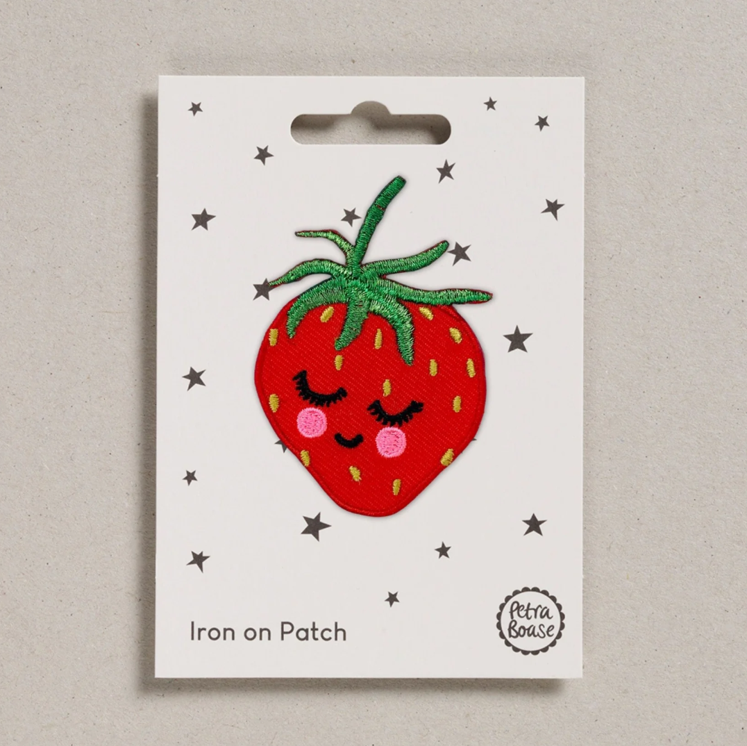 Embroidered iron on Smiling strawberry  patch, on a white card with black stars and 'Petra Boase' Branding 