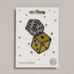 Embroidered iron on metallic rolled dice patch, on a white card with black stars and 'Petra Boase' Branding 