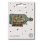 Embroidered  patch depicting a ship in a bottle with embroidered details in blue, gold, and multicolor, branded by Petra Boase, with an 'iron on' backing card.