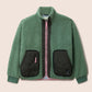Gandy's Green fleece jacket with black quilted pockets on a beige background