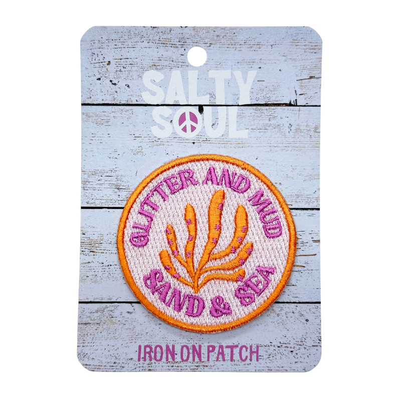 Embroidered  Iron-on patch with 'Glitter and Mud Sand & Sea' text and coral in pink and orange design on a 'Salty Soul' branded card.