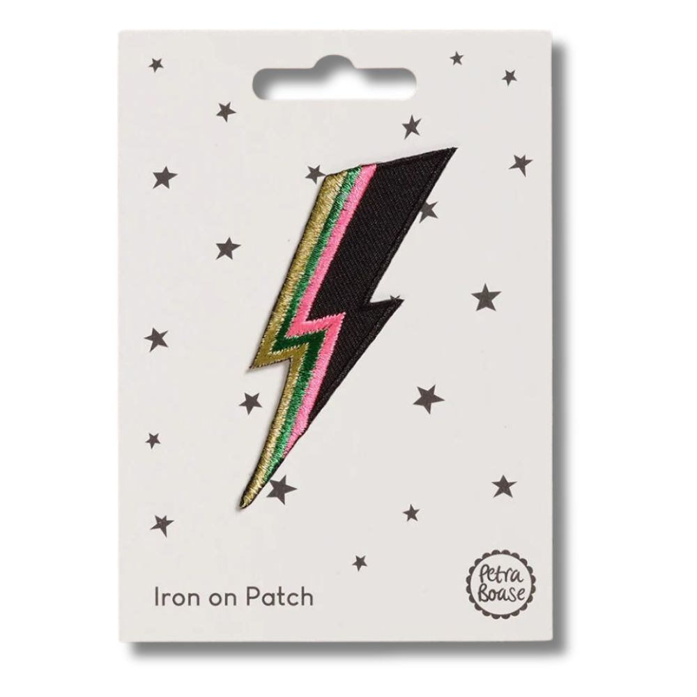 A patch depicting a lightning bolt with embroidered detailing, pinned onto a card with 'iron on patch' text and branding by Petra Boase.