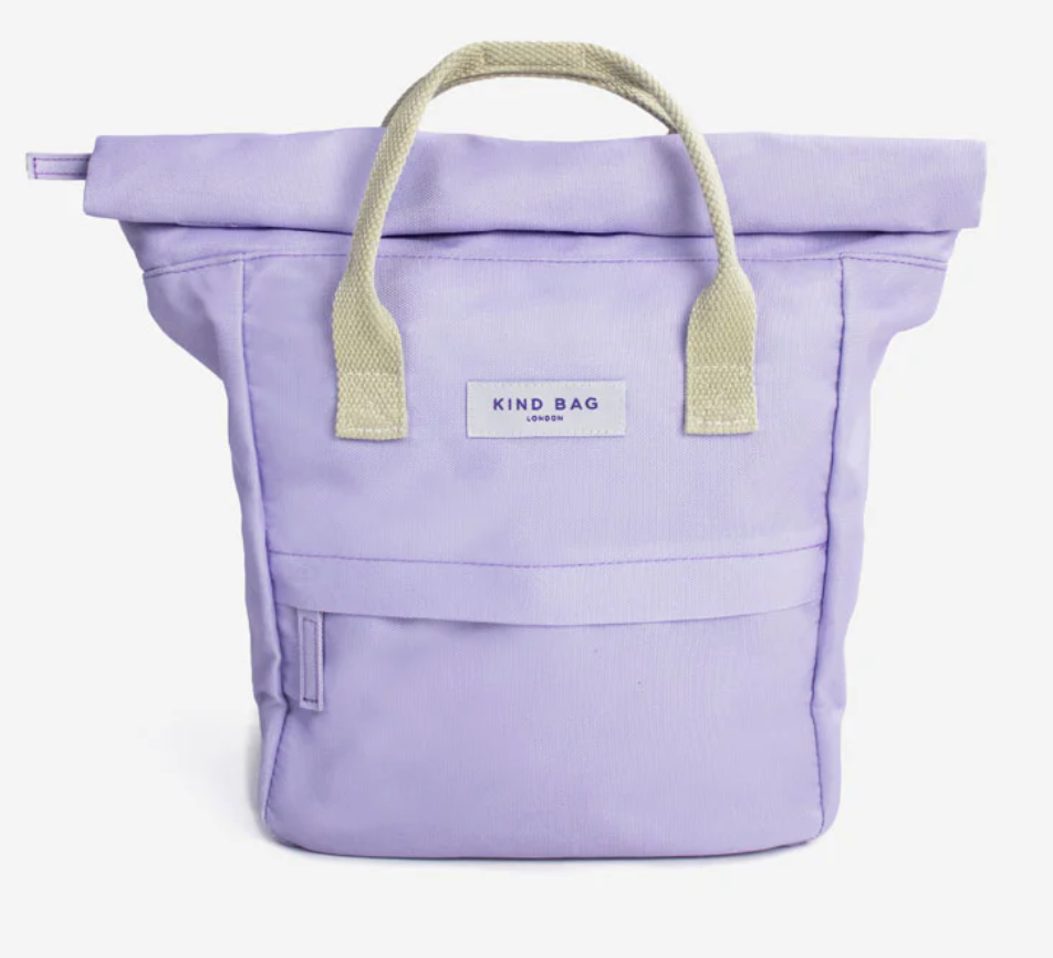 A lavender purple canvas backpack with light beige handles and a white brand label reading 'KIND BAG LONDON' on the front, shown against a plain white background.