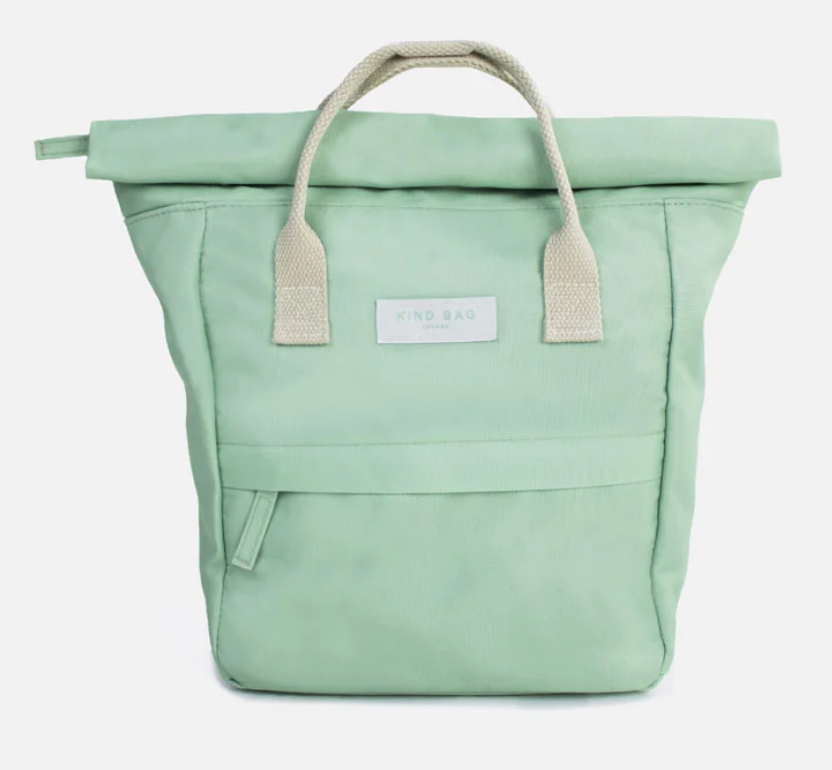 A mint green roll-top canvas tote bag with beige woven handles and a white 'KIND BAG' brand label on the front.