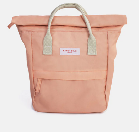 A peach-colored roll-top canvas tote bag with light beige webbed handles and a white brand label reading 'KIND BAG' on the front.