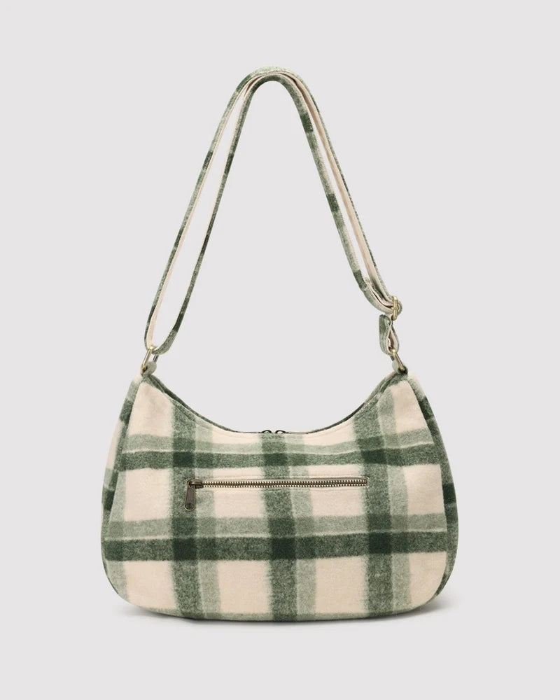 A green and cream plaid shoulder bag with a single shoulder strap and a front zippered pocket, shown against a light gray background.