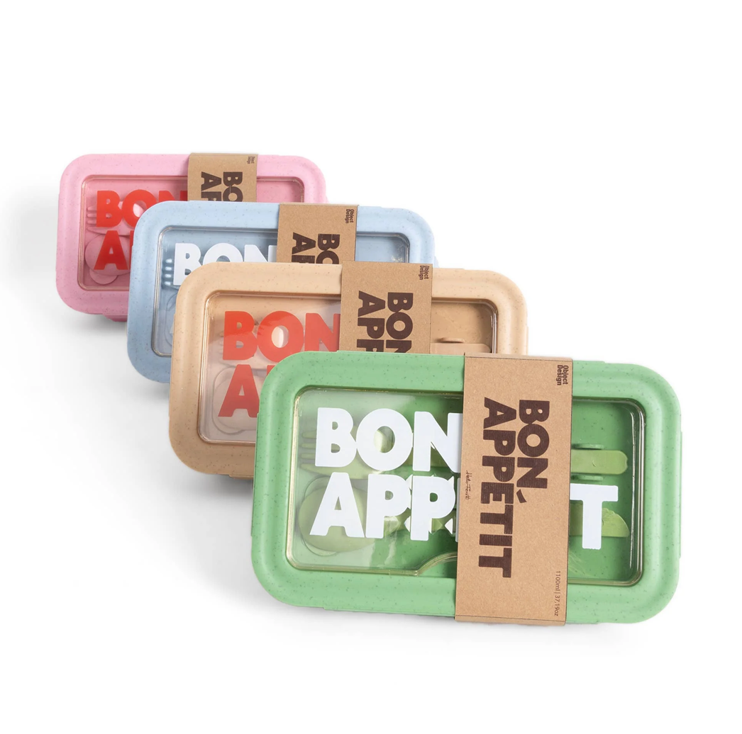 Set of colorful 'Bon Appetit' snack boxes with cardboard wraps on a white background