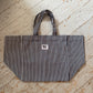 flat lay of striped salty soul tote on a wooden floor 