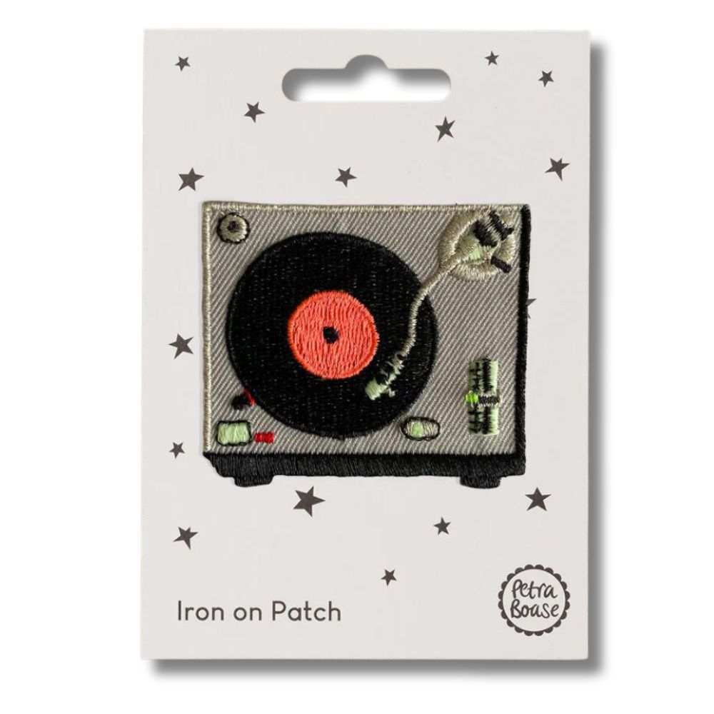 Red, black and grey record player/turn table iron on patch on a white card with 'petra boase' branding. on a white background. 