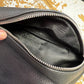 black leather XL bum bag showing silver zip opening and inside black zip within bag, on a wooden surface 