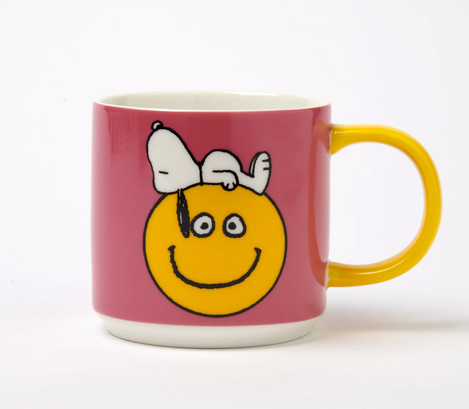 bright pink Mug with a smiley face design and Snoopy on a white background