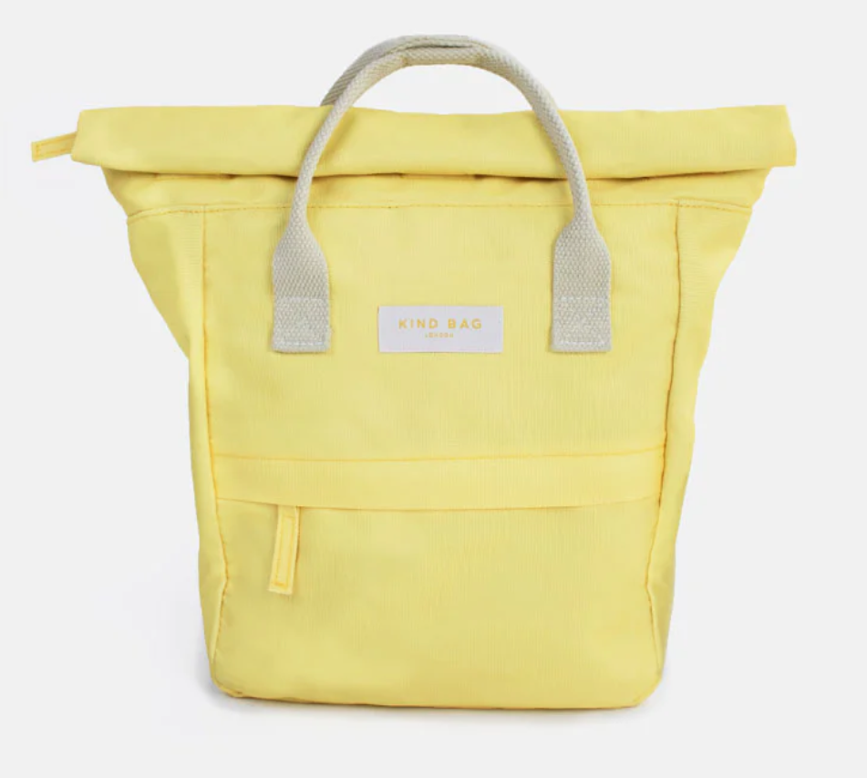 A light yellow roll-top tote bag with light cream fabric handles and a white brand label reading 'KING BAG' on the front, set against a plain light gray background.
