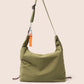 Gandys Green shoulder bag with a strap on a beige background