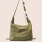 Gandys Green shoulder bag with a visible brand tag on a beige background