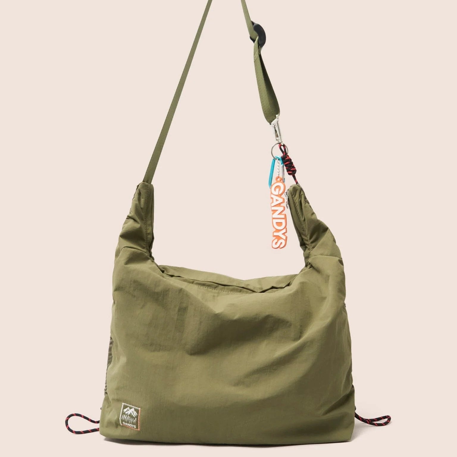 Gandys Green shoulder bag with a visible brand tag on a beige background