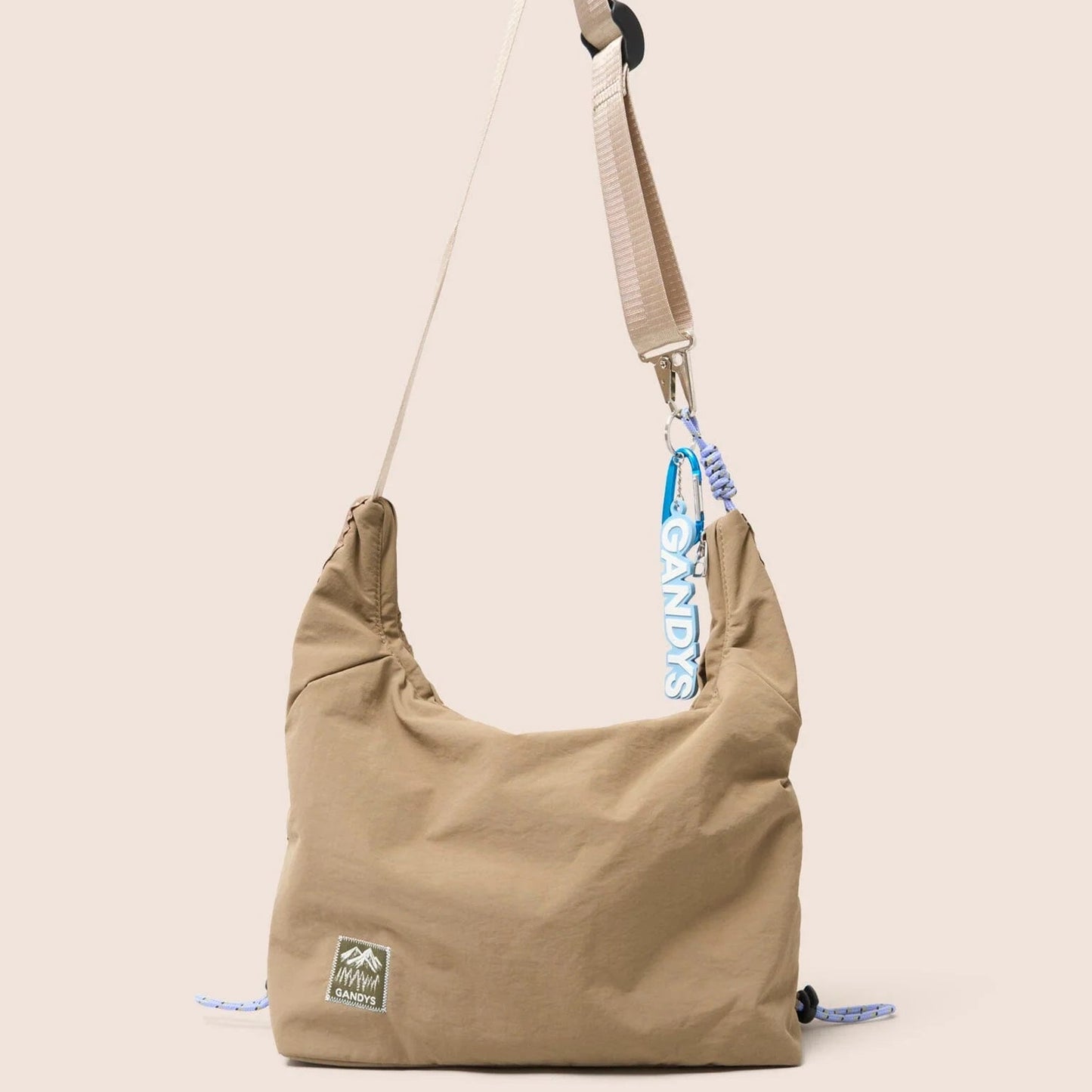 Gandys taupe shoulder bag with a strap on a beige background