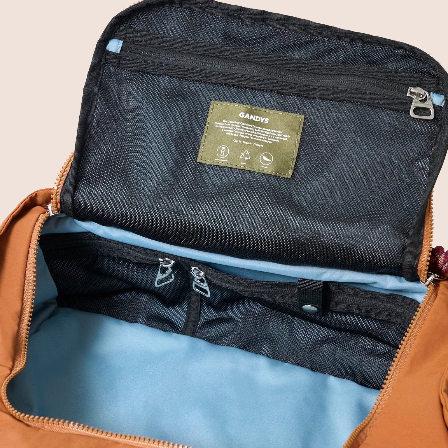 Open orange bag revealing a black interior with a visible brand label.