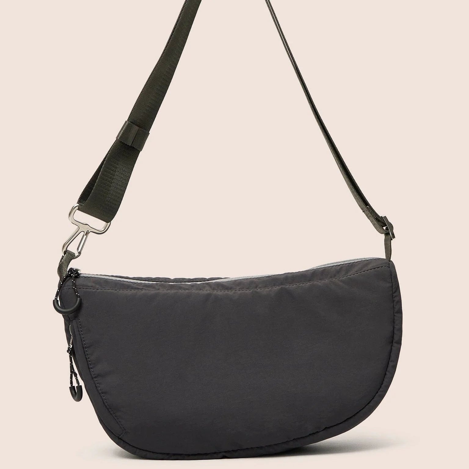 Black shoulder bag on a beige background