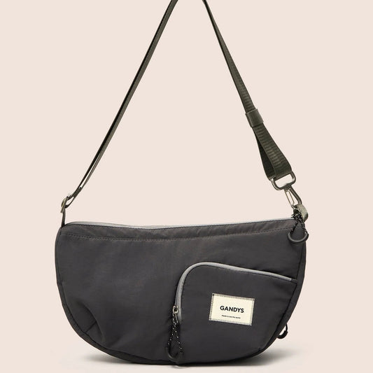 Gandys black shoulder bag with a visible brand logo on a beige background