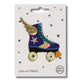Blue and colourful striped roller skate with gold wings iron on patch on a white card with black stars and 'petra boase' branding on a white background.