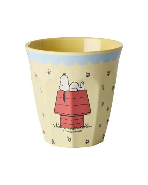 Yellow cup with Snoopy design on red dog house with blue trim around the top of the cup on a white background