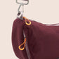 Gandys sling shoulder bag with a visible brand label on a beige background