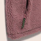 Close-up of a pink fleece jacket with a zipper on a light background
