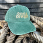 green coastal cowgirl Embroidered dad cap on a pile of ropes 
