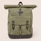 Green roll-top backpack with leather straps on a beige background