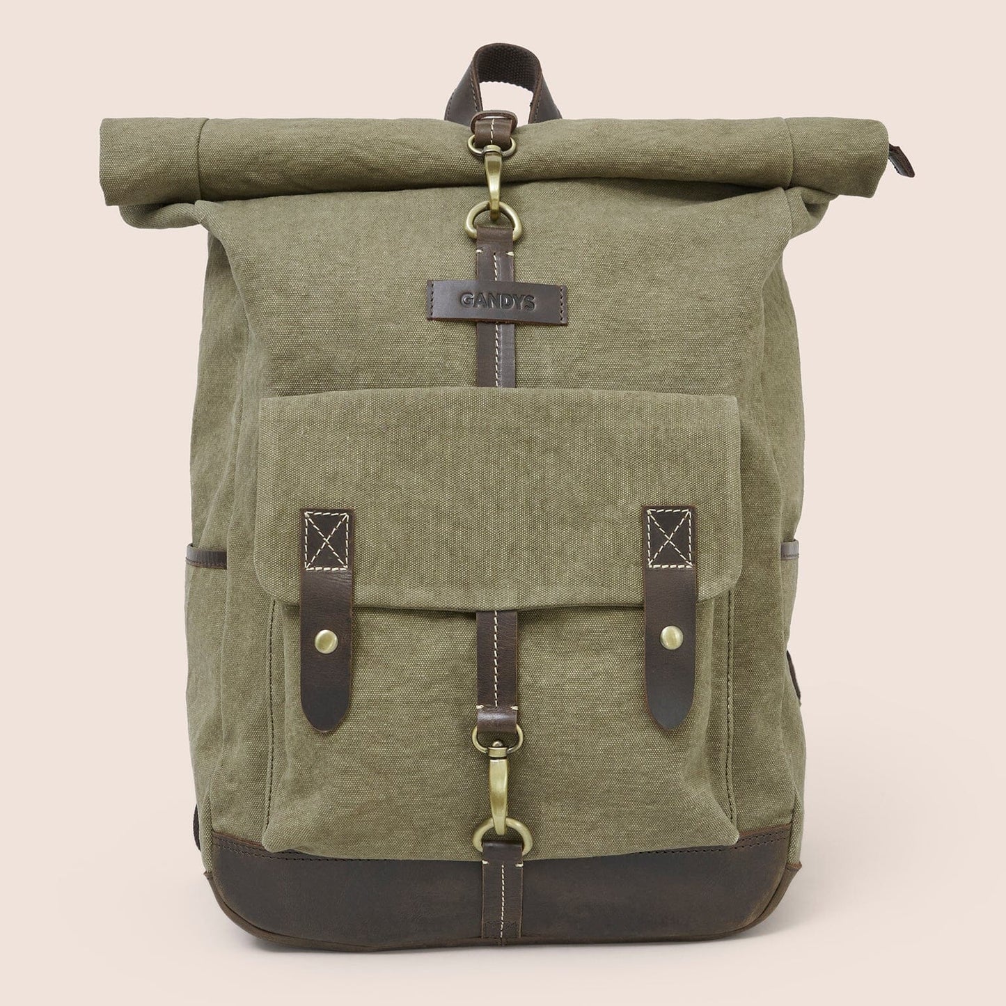 Green roll-top backpack with leather straps on a beige background
