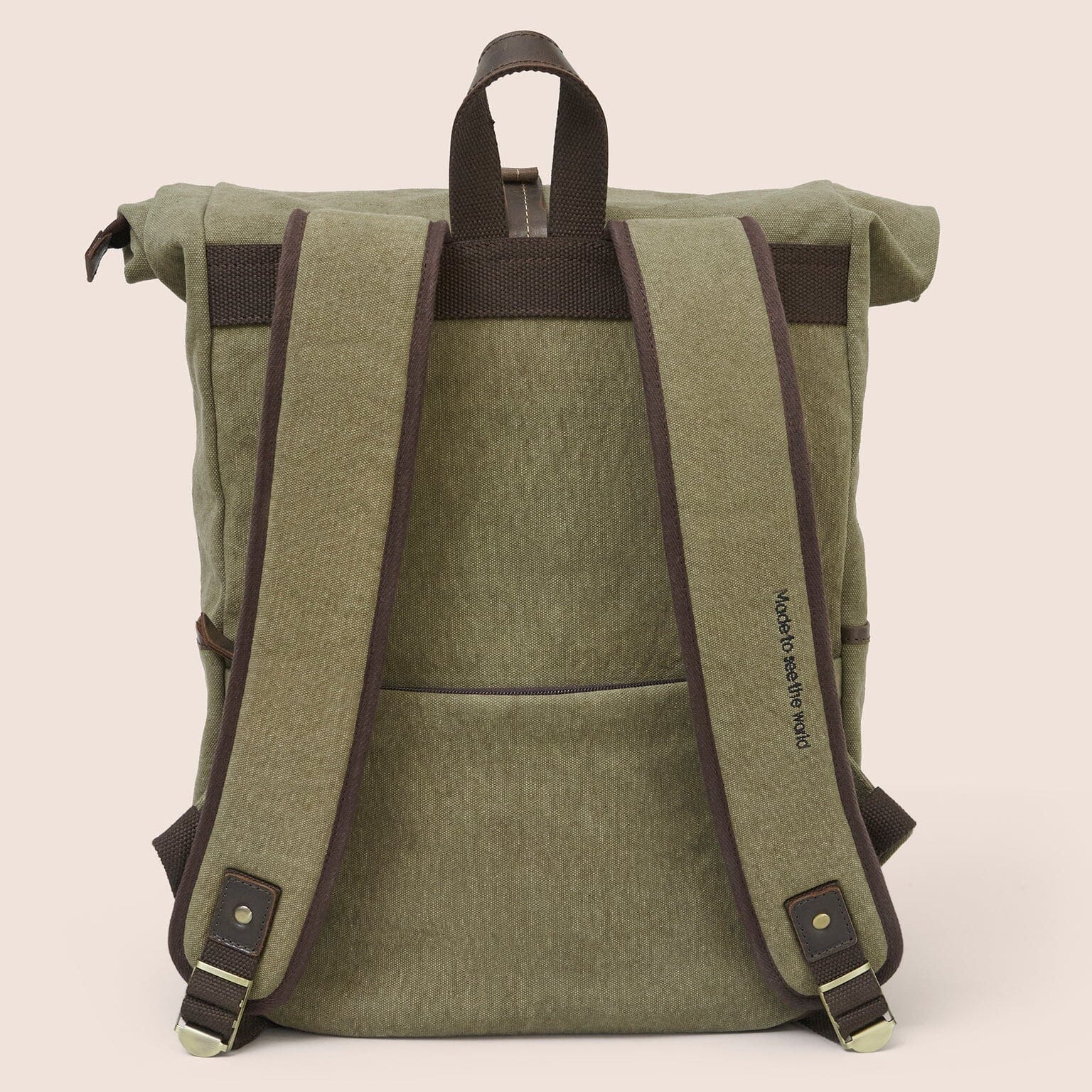 Gandys green roll-top backpack with brown straps on a beige background