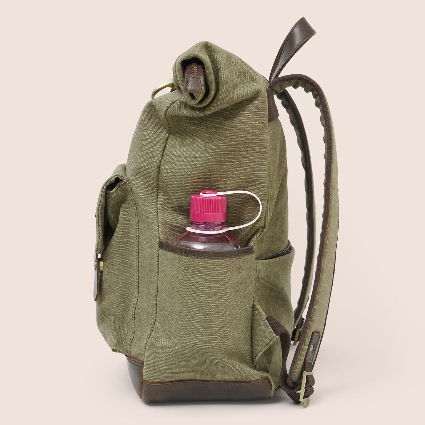 Gandys green backpack with a water bottle holder on a beige background