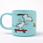 Light blue mug with a cartoon snoopy dog on an orange skateboard design