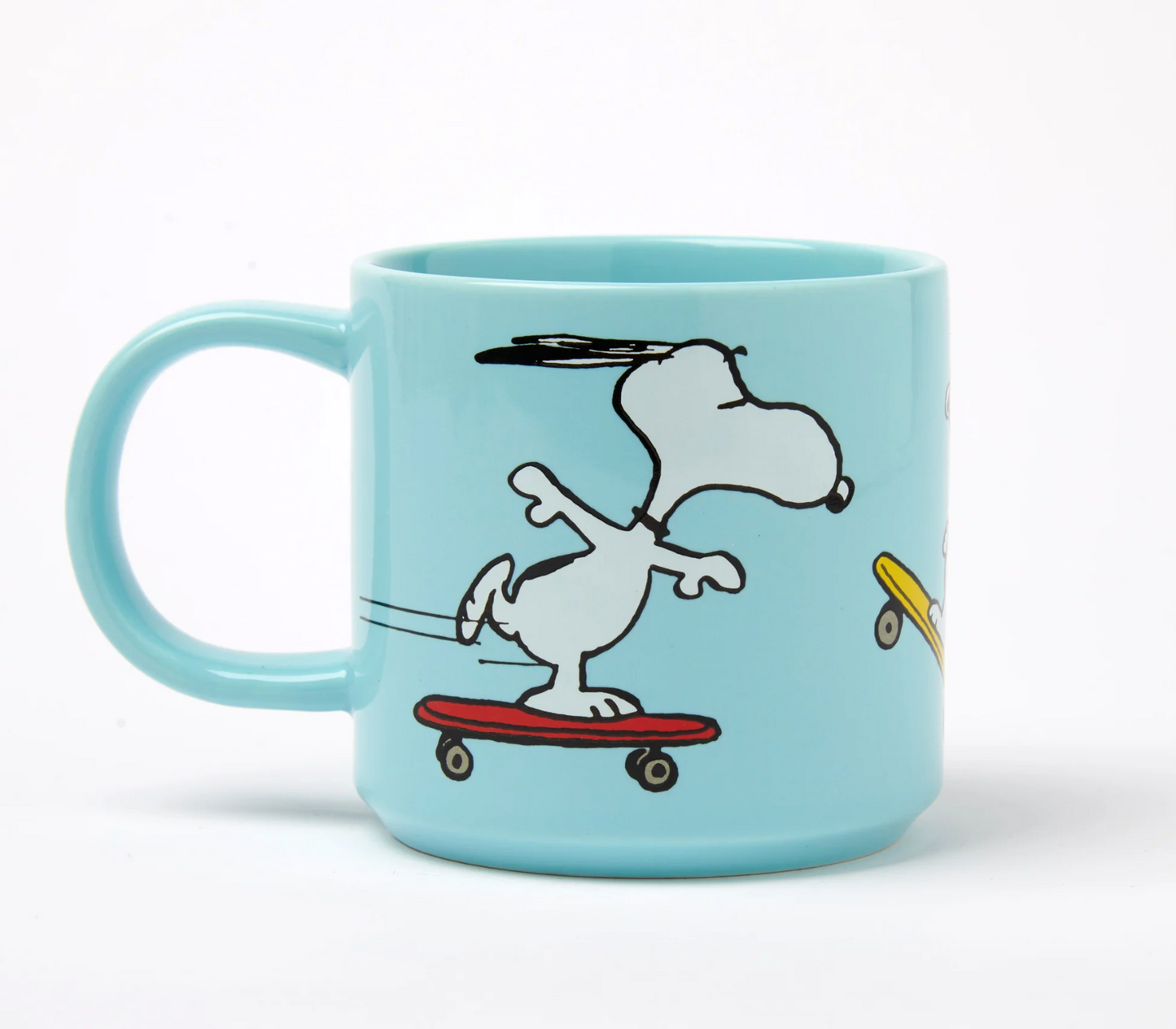 Light blue mug with a cartoon snoopy dog on an orange skateboard design