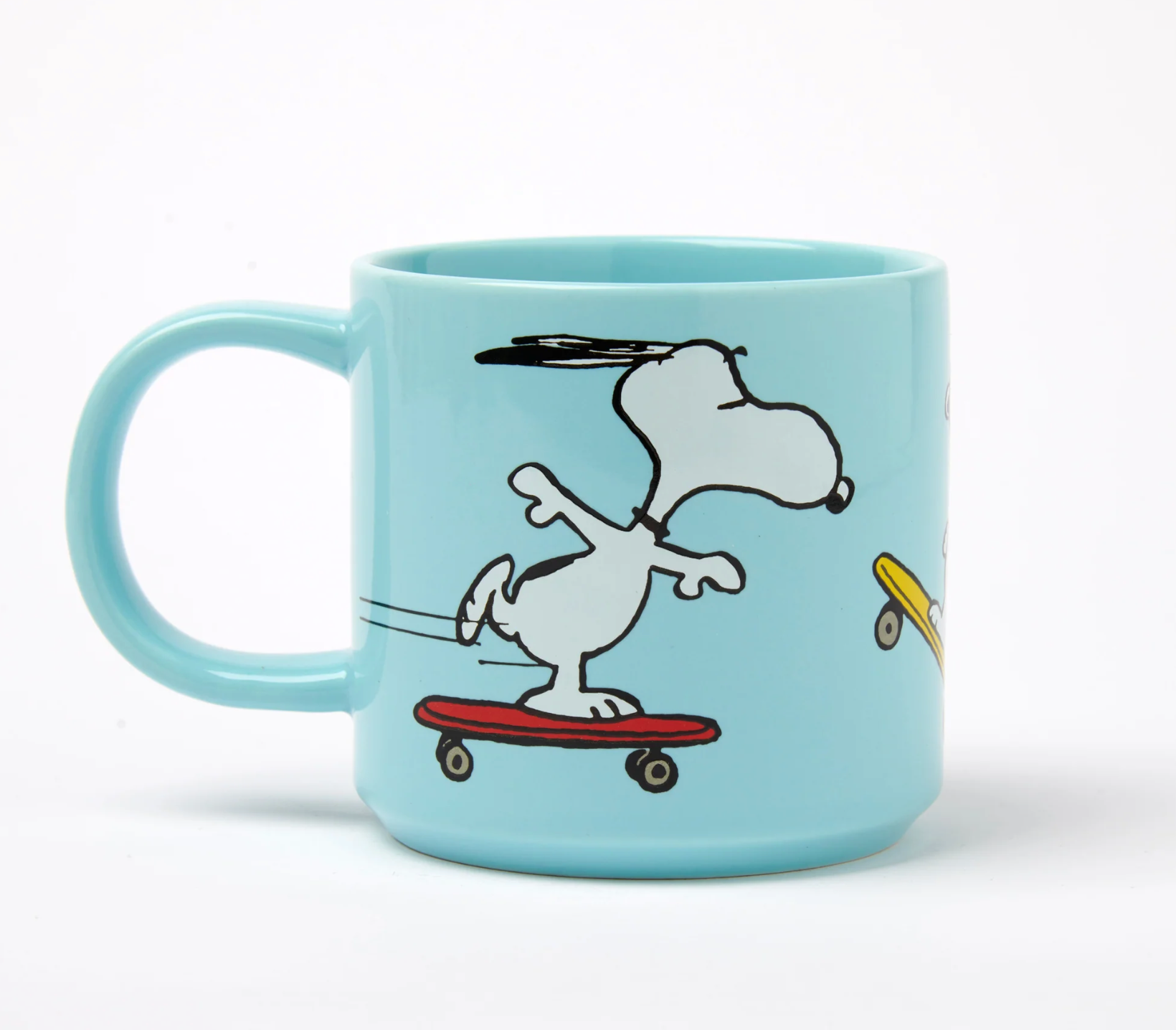 Light blue mug with a cartoon snoopy dog on an orange skateboard design
