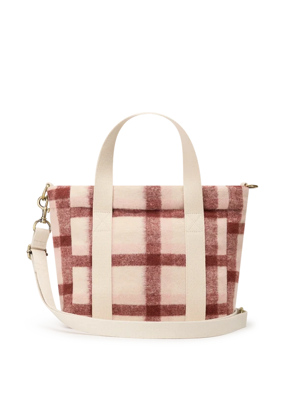 A small woven tote bag with a cream and dusty rose plaid pattern, featuring dual top handles and a matching adjustable shoulder strap, shown against a plain white background.