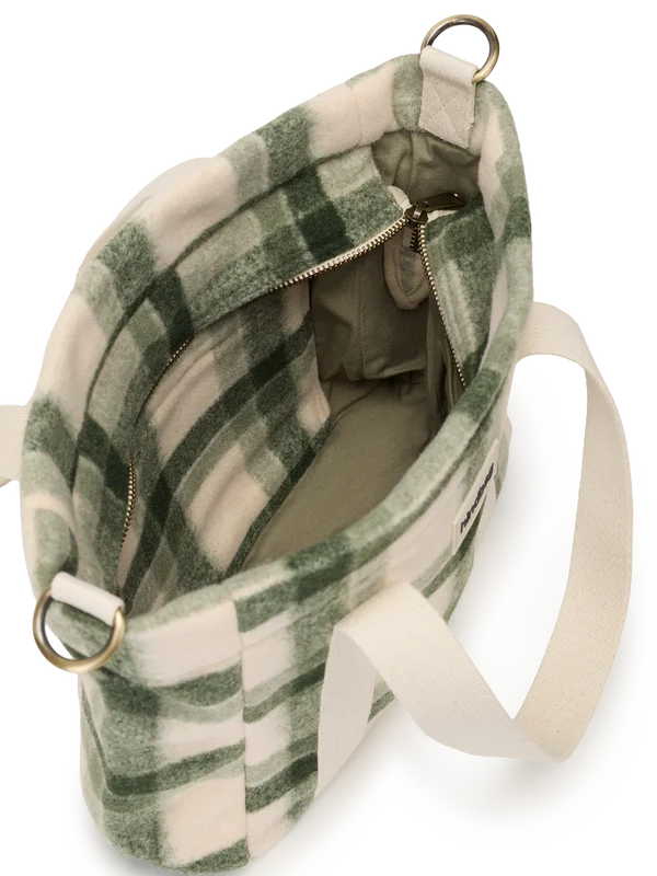 A green and cream plaid fleece shoulder bag with a wide cream fabric strap and gold-tone metal hardware, shown from an overhead angle on a white background.